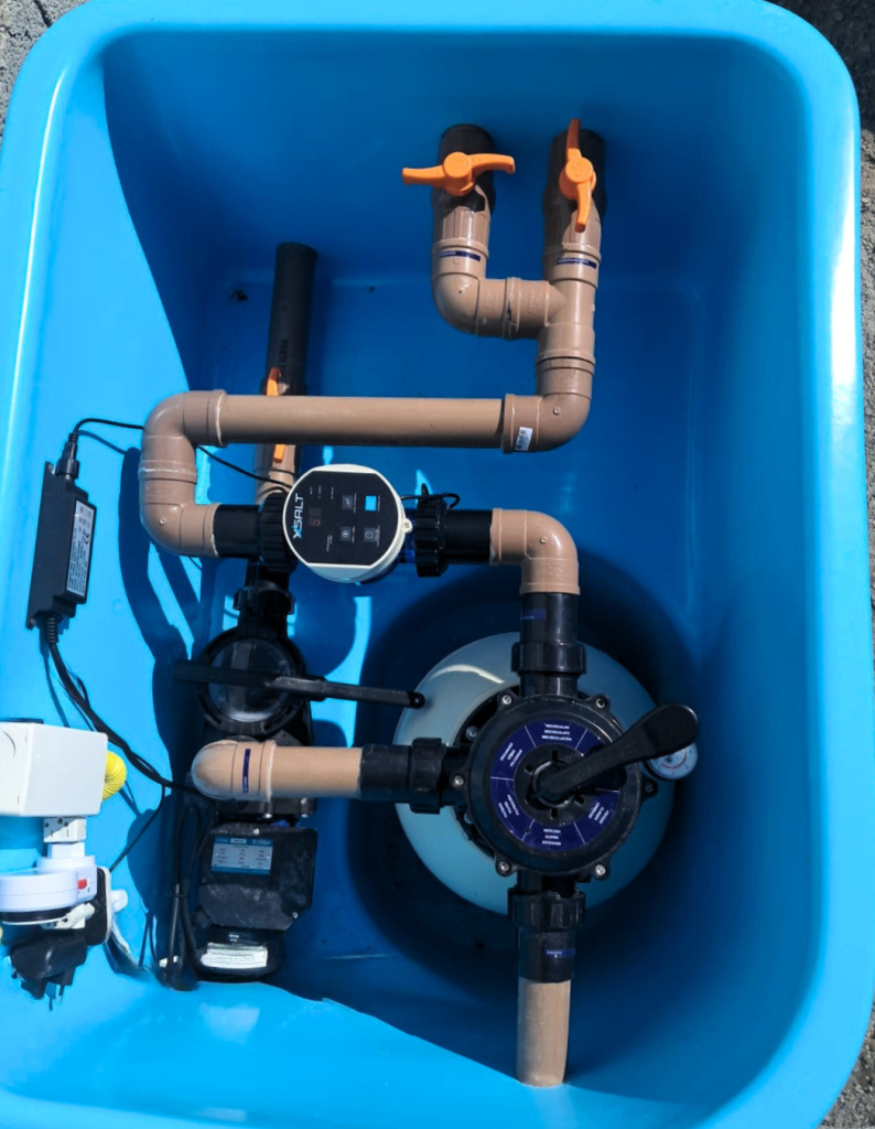 XSALT system in a fiber machine room — compact setup in blue tub with pump, filter and control panel